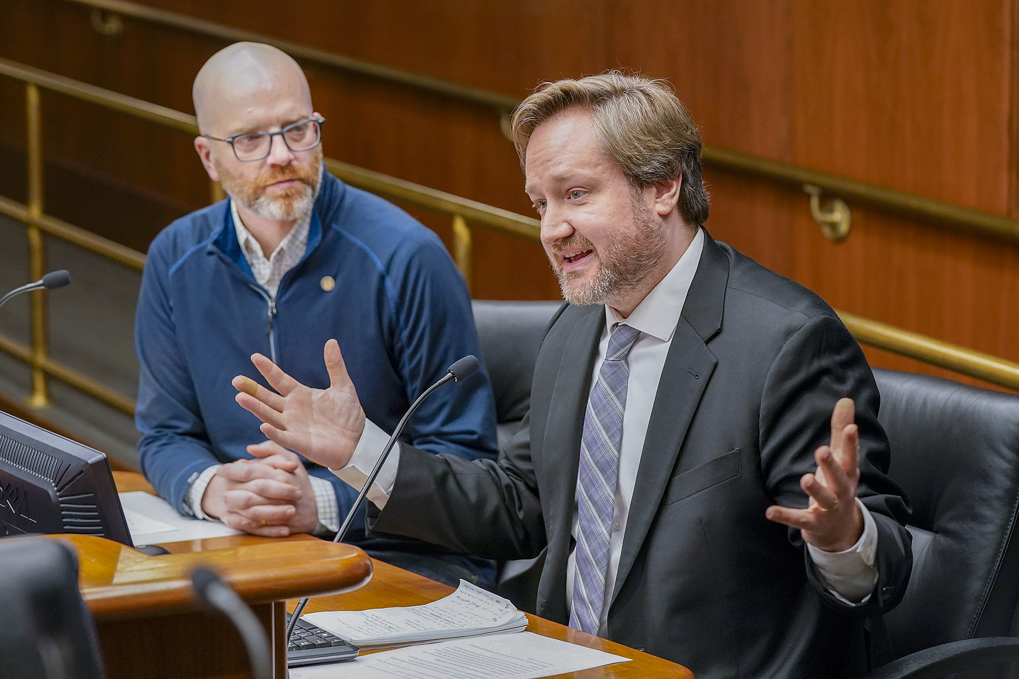 Chris Stinson, SEIU Local 284 policy coordinator, testifies March 27 before the House Education Finance Committee in support of HF1348. Rep. Brad Tabke, left, is the sponsor. (Photo by Michele Jokinen)